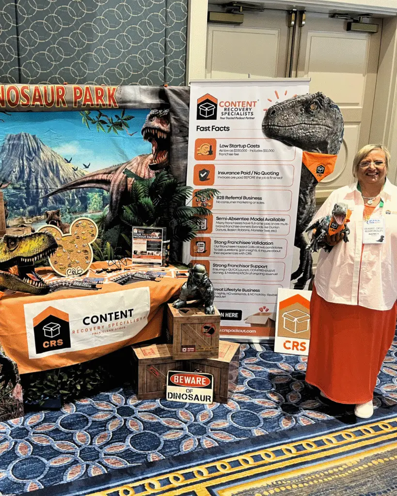 Nancy Haverty poses in front of the CRS Booth at the Franserve Conference
