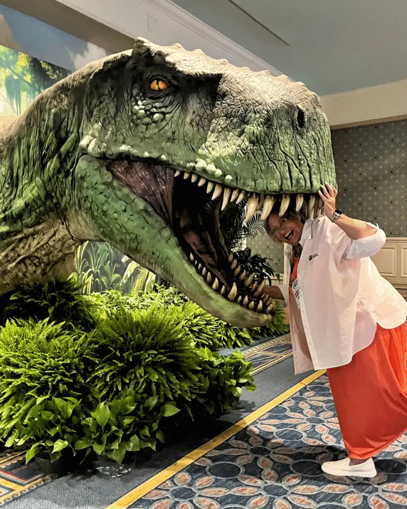 Nancy Haverty puts her head inside a giant dinosaur
